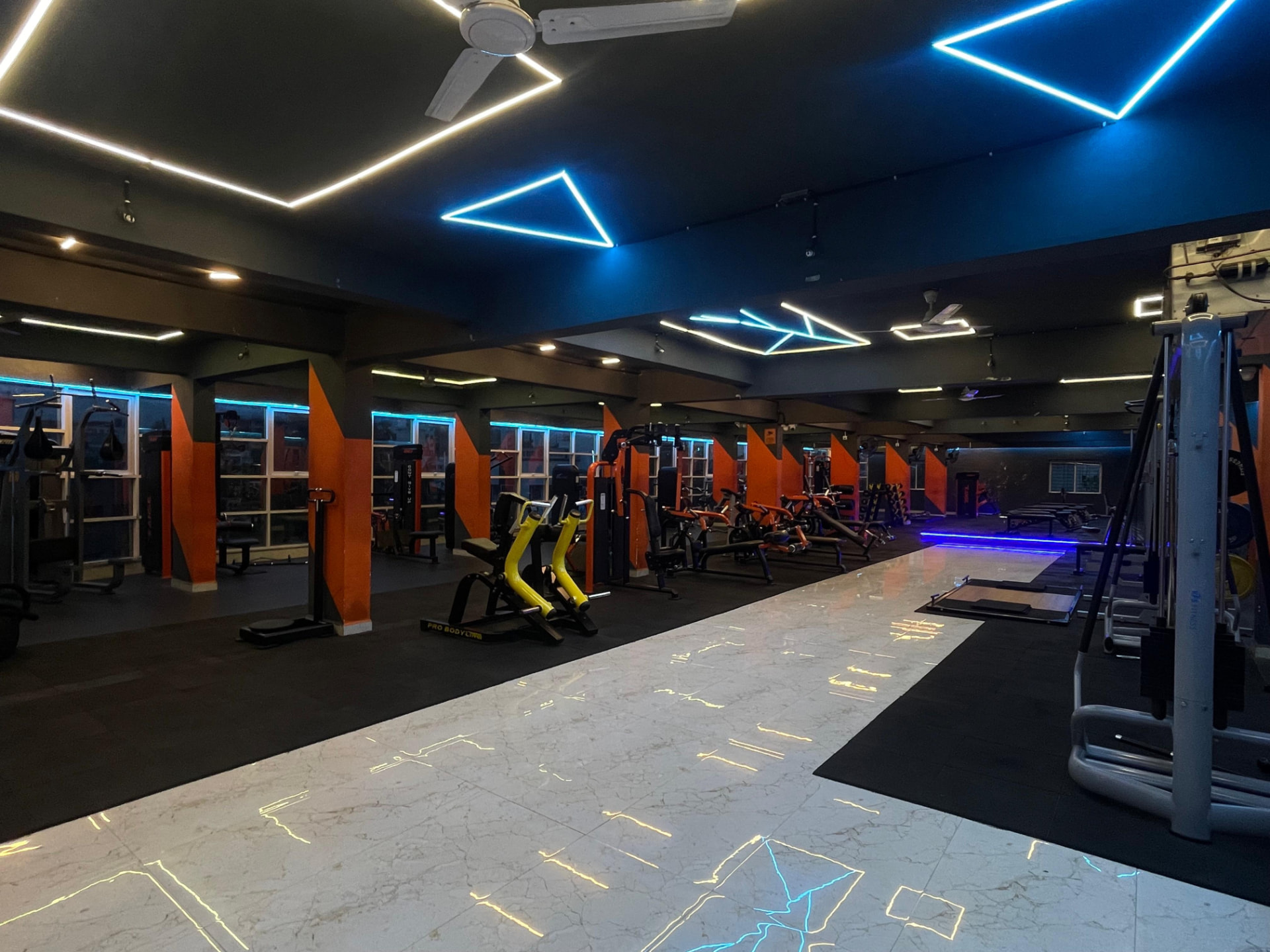 Wide view of the plate-loaded equipment section on the main training floor of SK Fitness Gym Kharadi, Pune