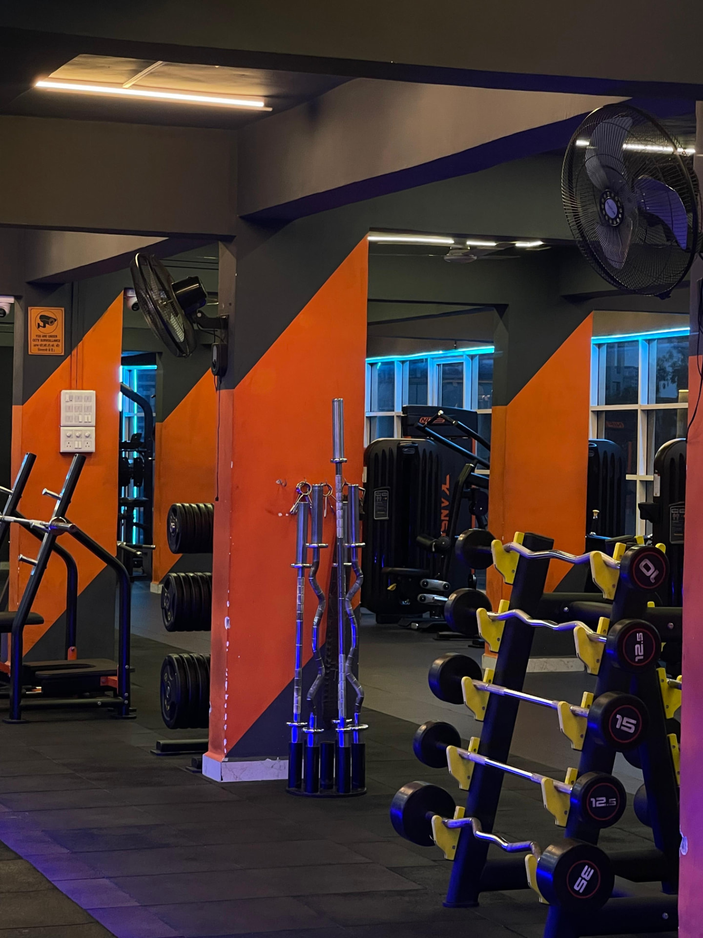 Olympic barbell and weight plate storage rack at SK Fitness Gym near Jadhav Hospital, Kharadi, Pune