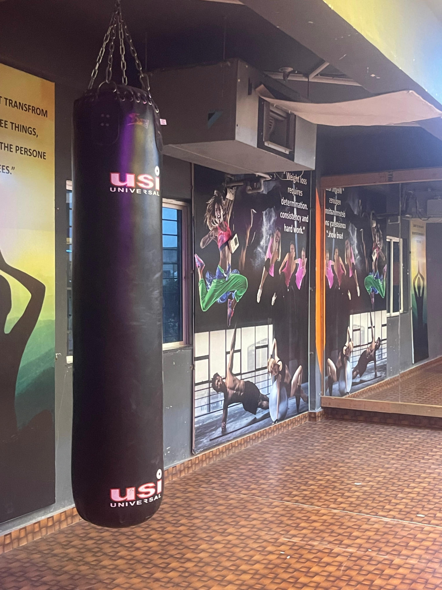 Heavy punching bag and motivational wall graphics in the functional training studio at SK Fitness Gym Kharadi