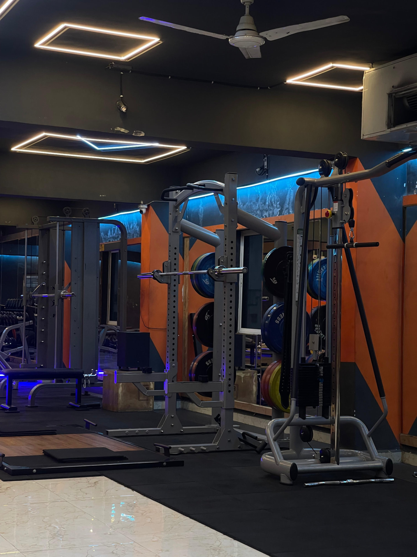 Squat rack, bumper plates and cable crossover station for strength training at SK Fitness Gym Kharadi