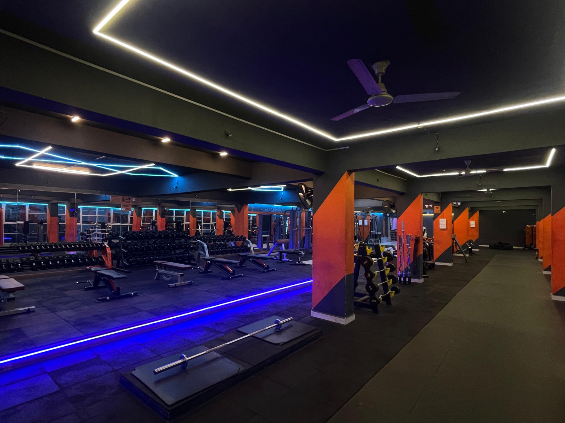 Dumbbell racks facing a full mirrored wall in the strength hall at SK Fitness Gym Kharadi, Pune